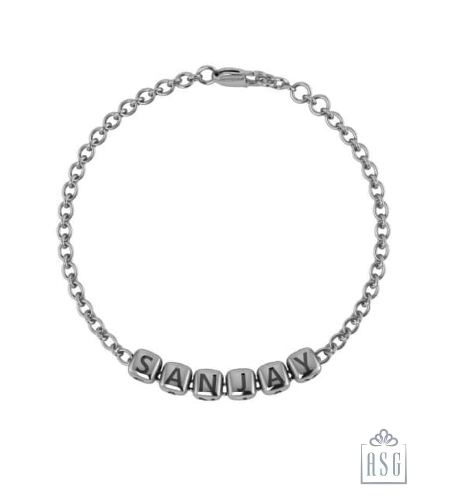 Boy tag charm in silver with blue enamel finish on a clasping link bracelet.  | Tiffany & Co.